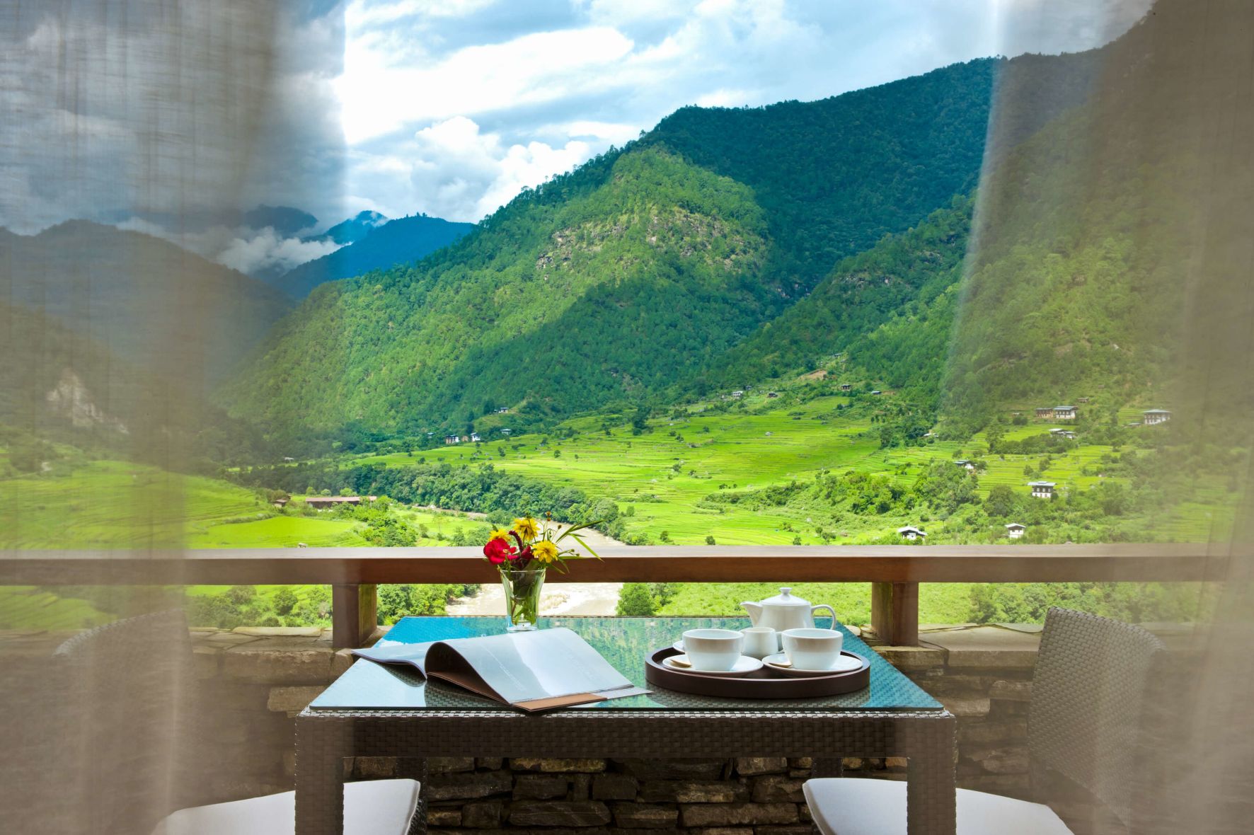 A Table With A Laptop On It In Front Of A Valley