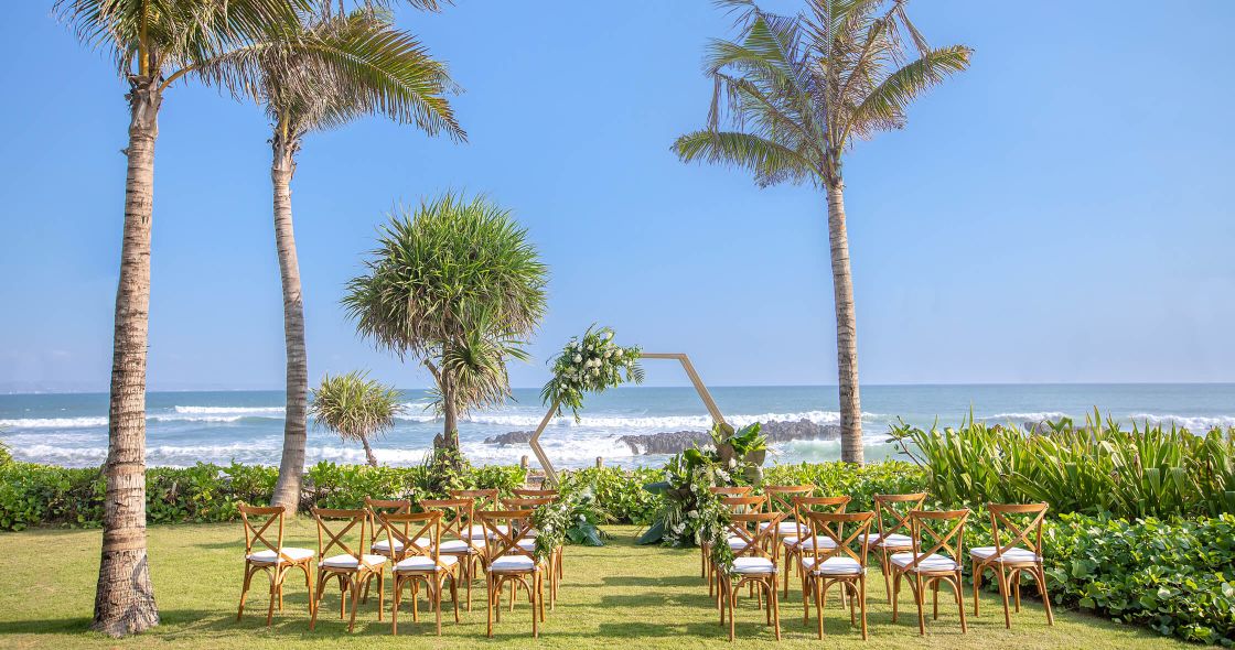 A Group Of Tables And Chairs Next To A Beach