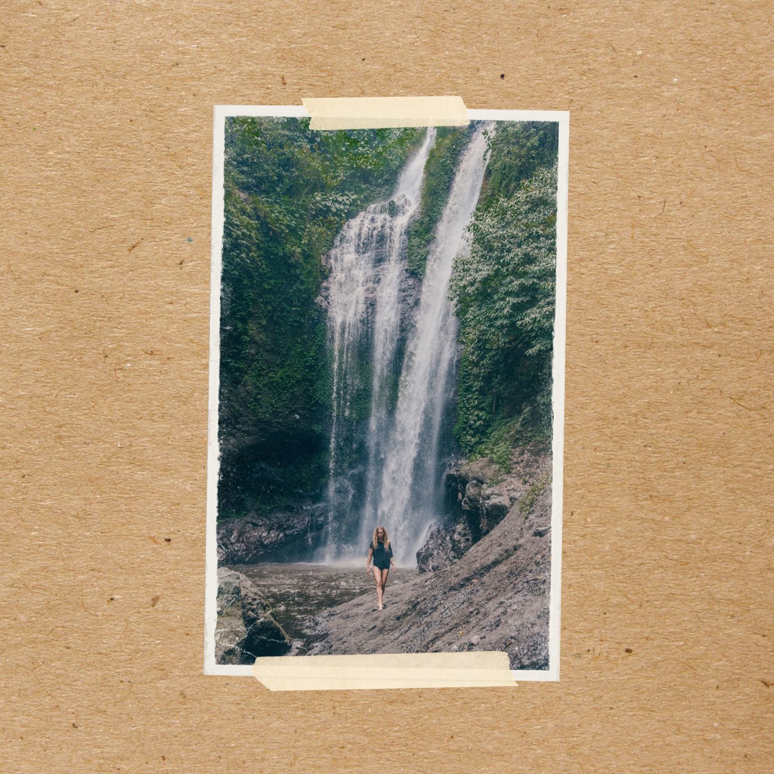 A Person Standing In Front Of A Waterfall