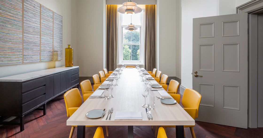 A Dining Room Table With Yellow Chairs