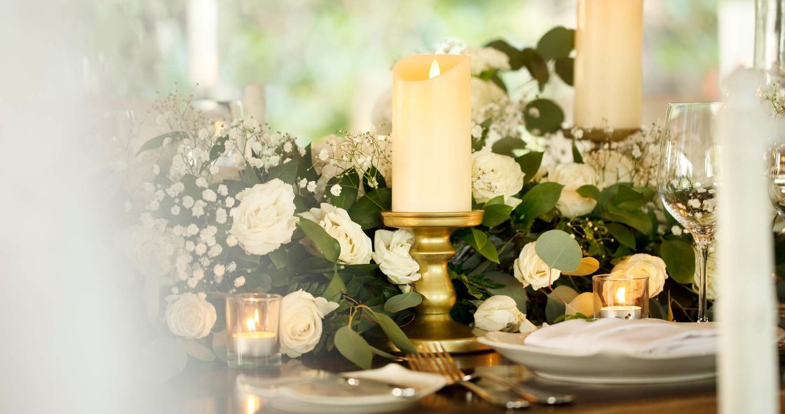 A Table With White Flowers And Candles