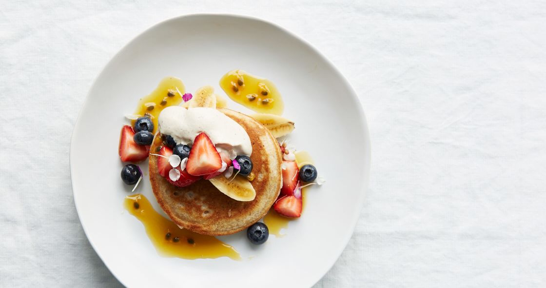 A Plate Of Pancakes With Fruit On Top