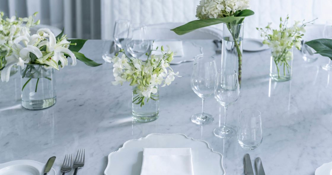A Table With Glass Vases And Flowers
