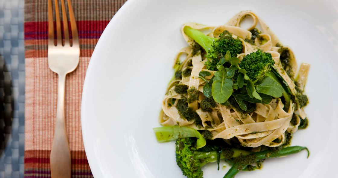 A Plate Of Pasta With Broccoli And A Fork