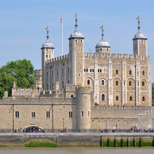 A Castle With A Moat With Tower Of London In The Background