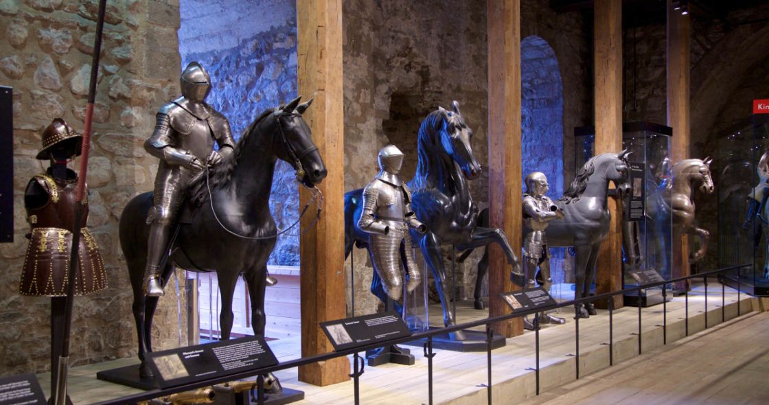 A Group Of Statues Of Men On Horses