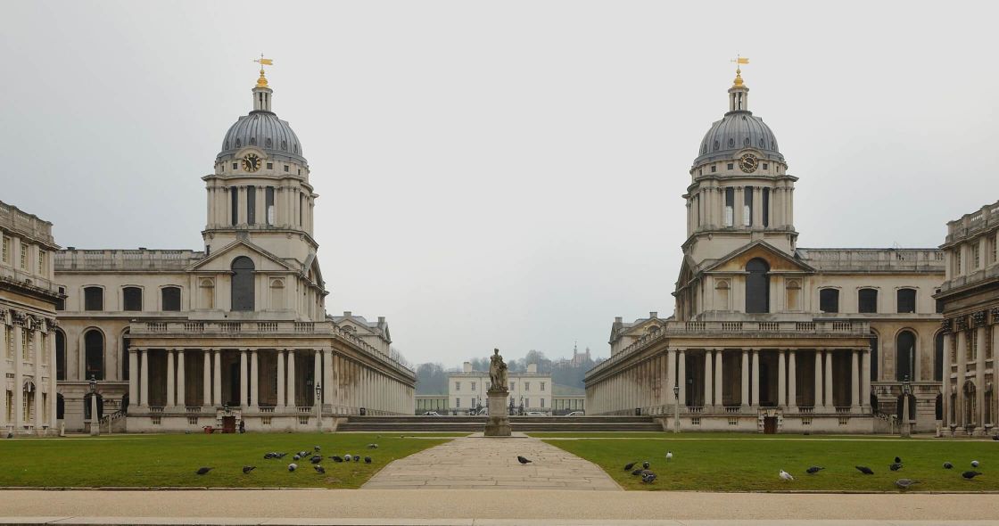 A Large Building With A Statue In Front Of It With Greenwich In The Background