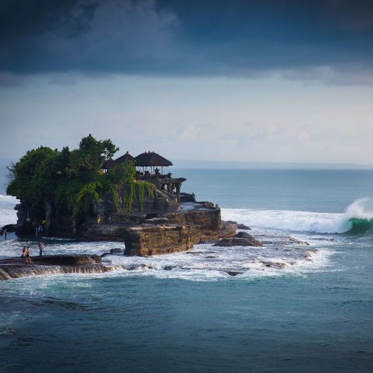A Small Island With Tanah Lot On It Surrounded By Water