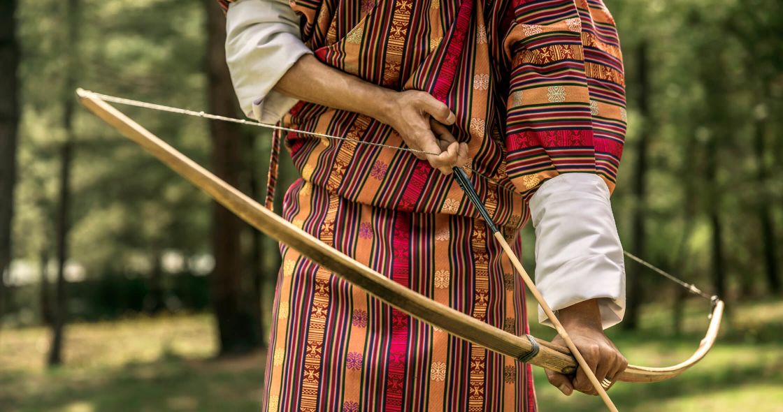A Person Holding A Bow And Arrow
