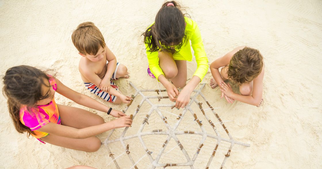A Group Of Children Playing With Sand