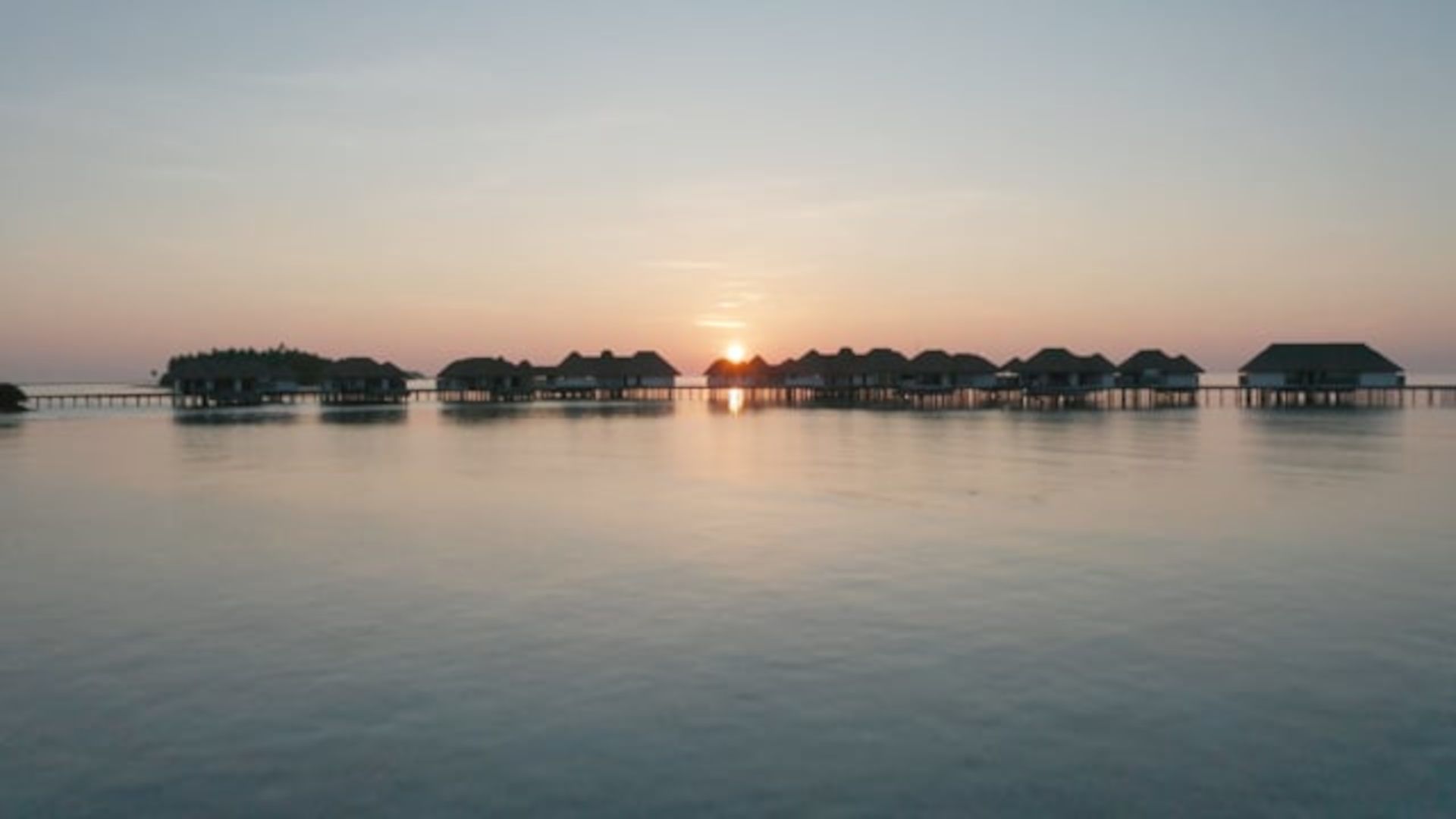 A Body Of Water With Buildings And Trees In The Background