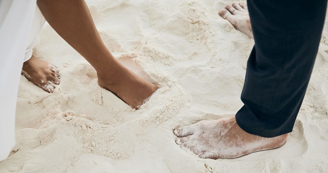 A Pair Of Feet In Sand