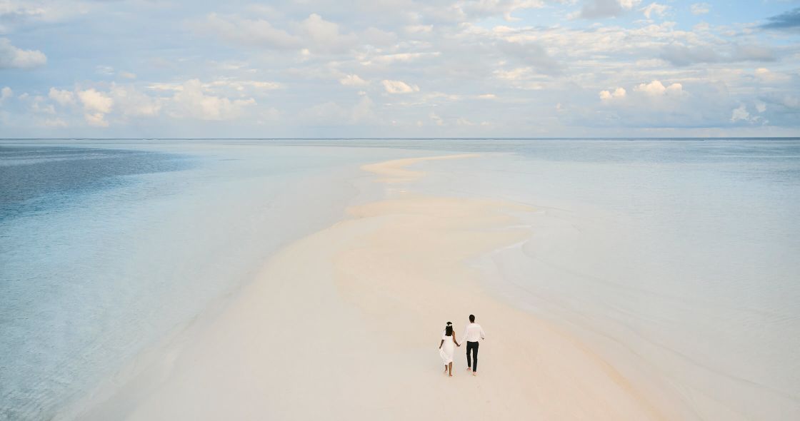 A Couple Walking On A Beach