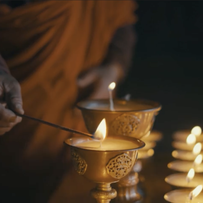 A Person Lighting A Candle Image