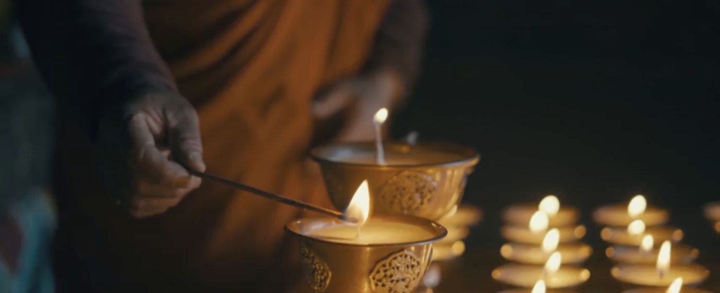 A Person Lighting A Candle
