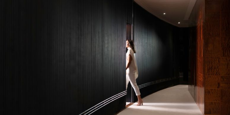 A Woman Walking Down A Hallway