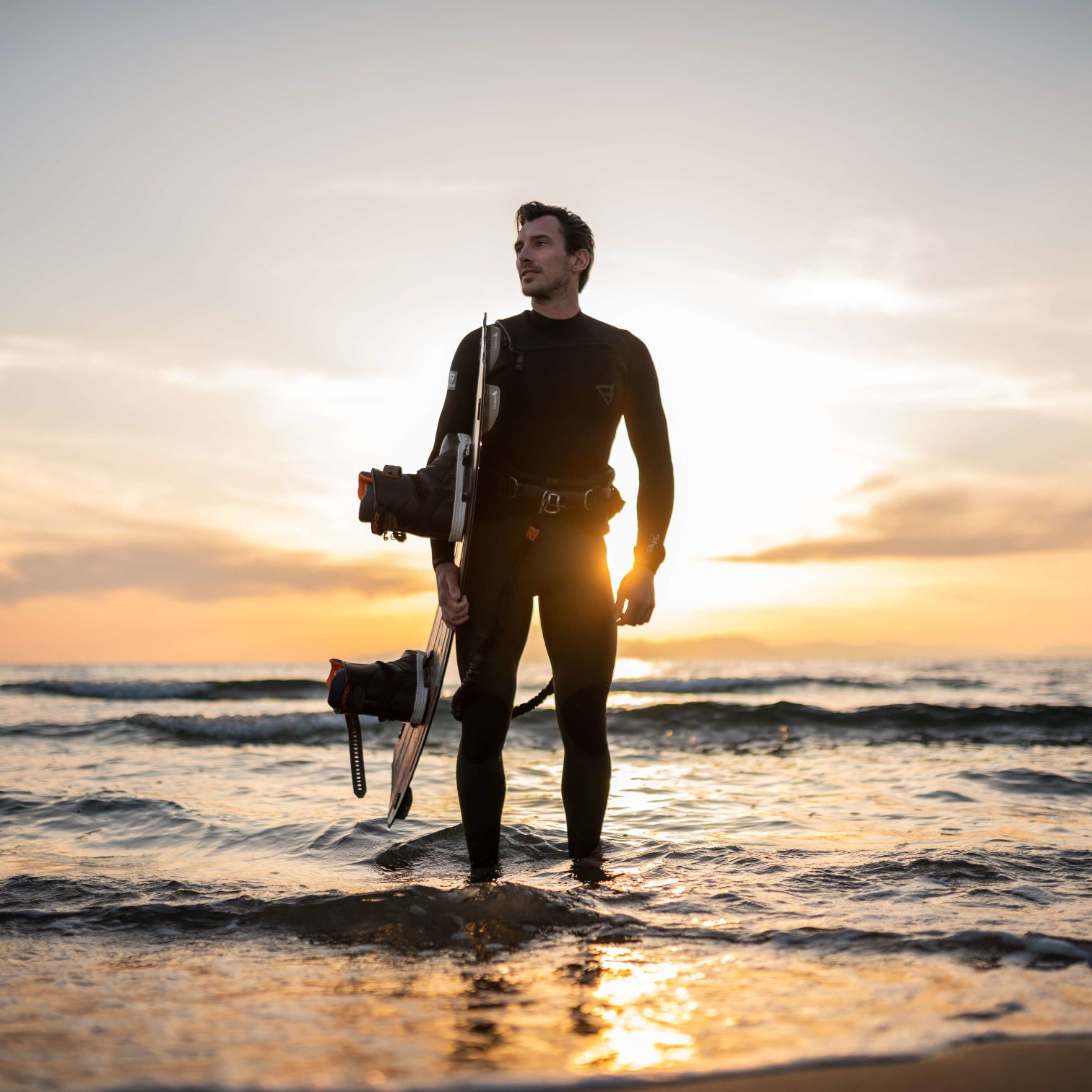 Kyle Mills Holding A Dog On A Beach