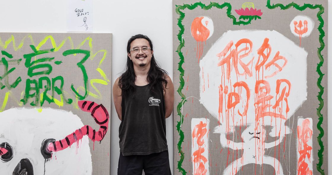 Choua Xiong Standing In Front Of A Wall With Graffiti