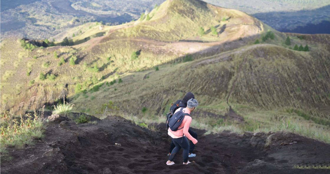 A Man With A Backpack On A Rocky Hill