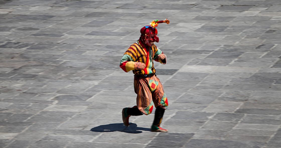 A Person Wearing A Colorful Outfit And Holding A Sword