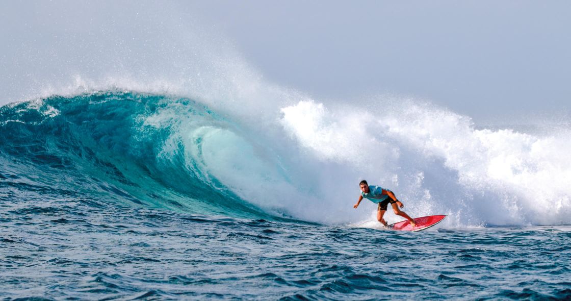 A Man Surfing A Wave