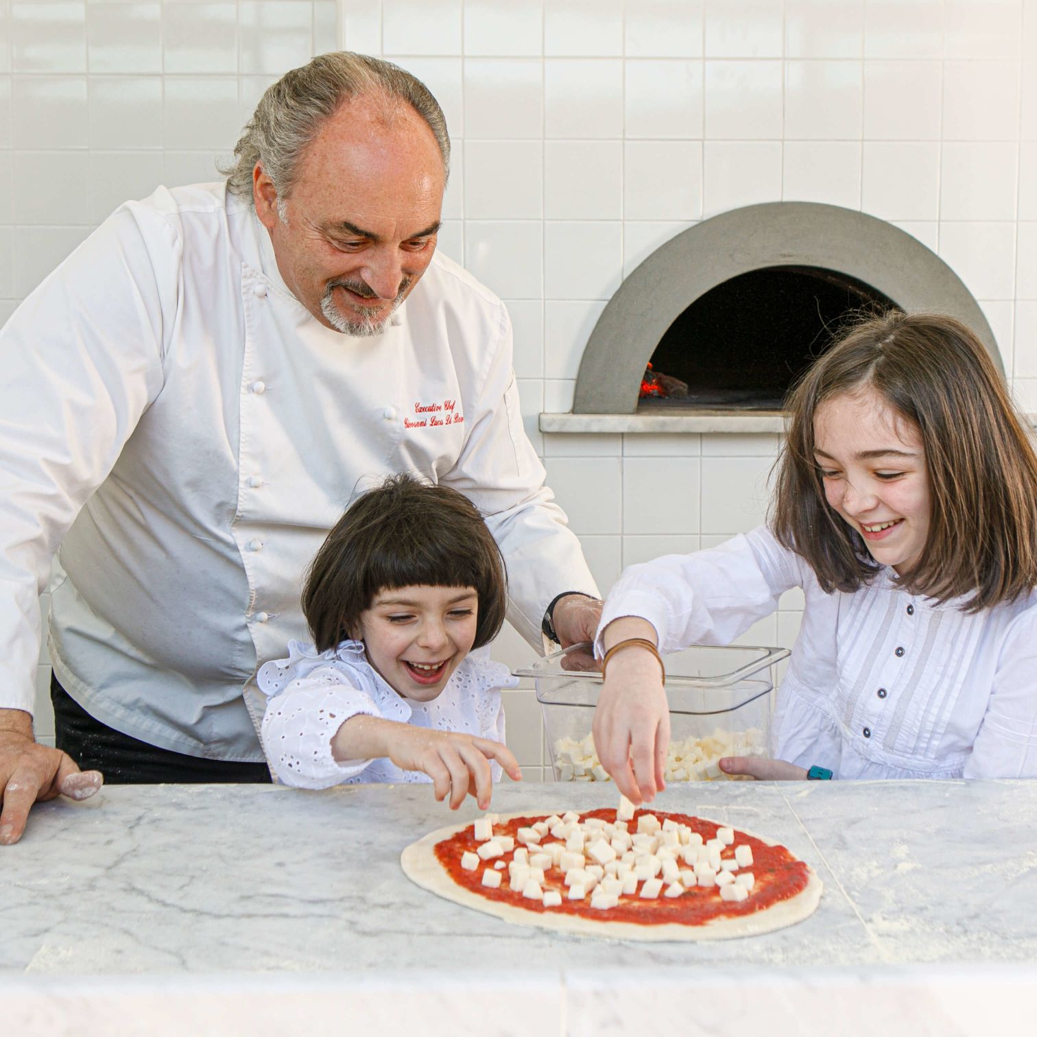 Peter DaCunha Et Al. With A Child In Front Of A Pizza