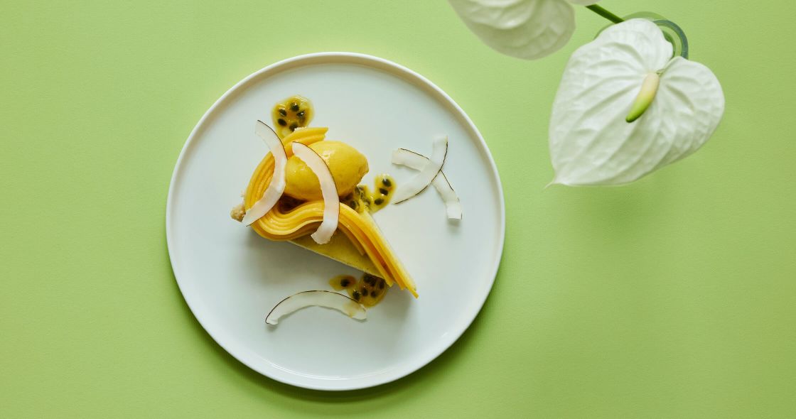 A Plate With A Banana And A Flower On It