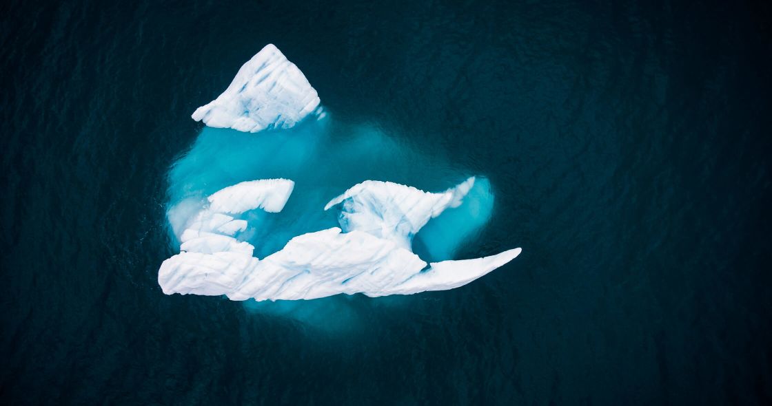 A Blue Iceberg In The Water