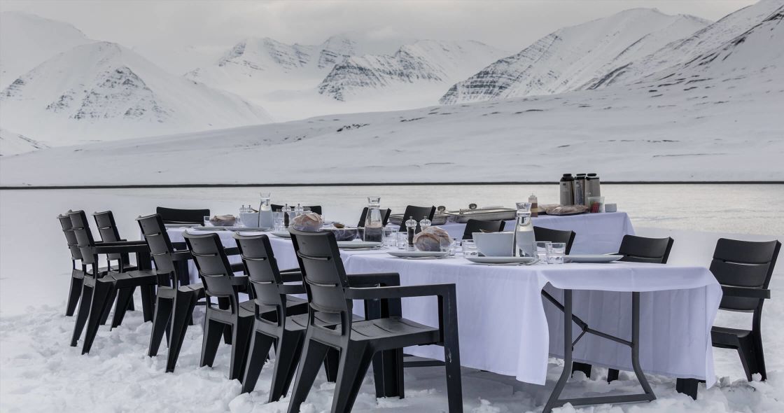 A Table With Chairs And A Table In The Snow